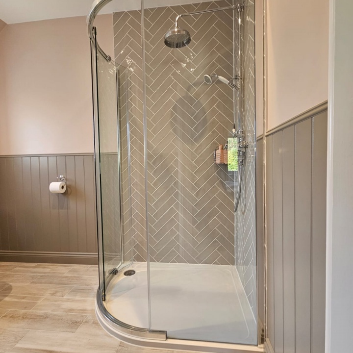 En-Suite Shower room : Corner cubicle tiled herringbone style.